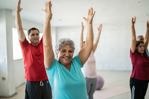People excited doing yoga stretches